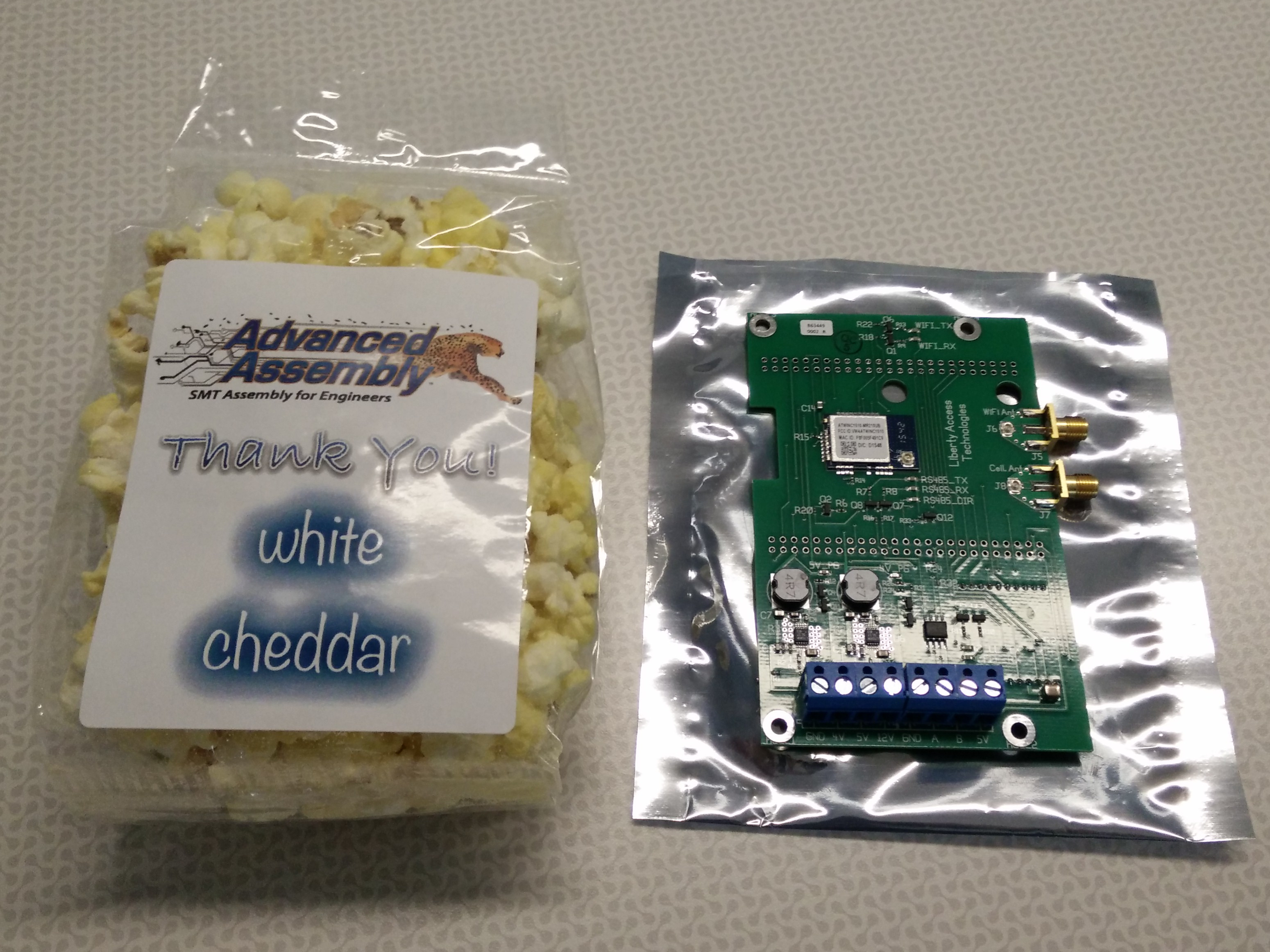 A circuit board that I designed and had assembled for Liberty Plugins. There's popcorn next to it.